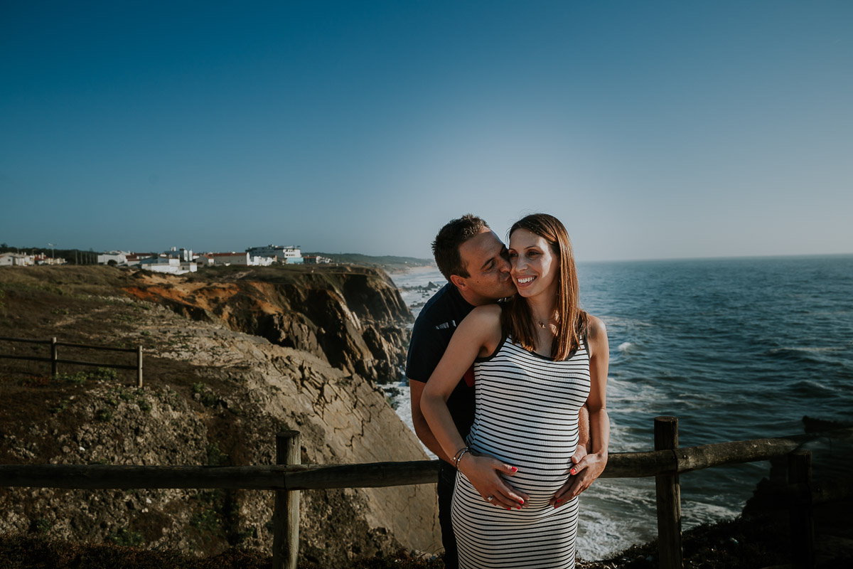 femme enceinte au bord de plage se faisant embrasser frederico santos